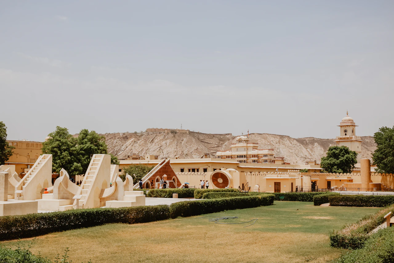 Jantar Mantar instruments and lawns beneath the hills in Jaipur